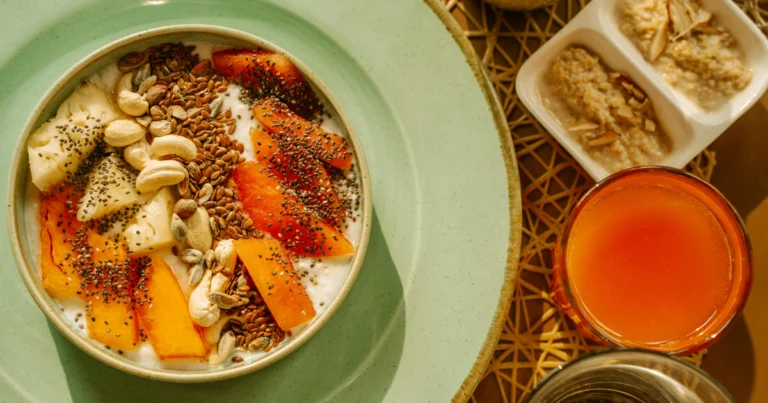 A bowl of yogurt topped with fresh fruits and seeds, a perfect high-protein snack for busy lifestyles