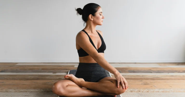 Woman stretching on a yoga mat as part of her post-workout recovery routine