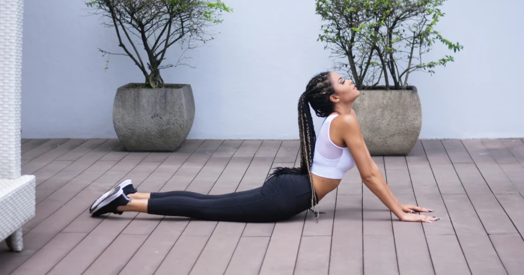 Woman stretching and practicing mindfulness as part of her post-workout recovery routine